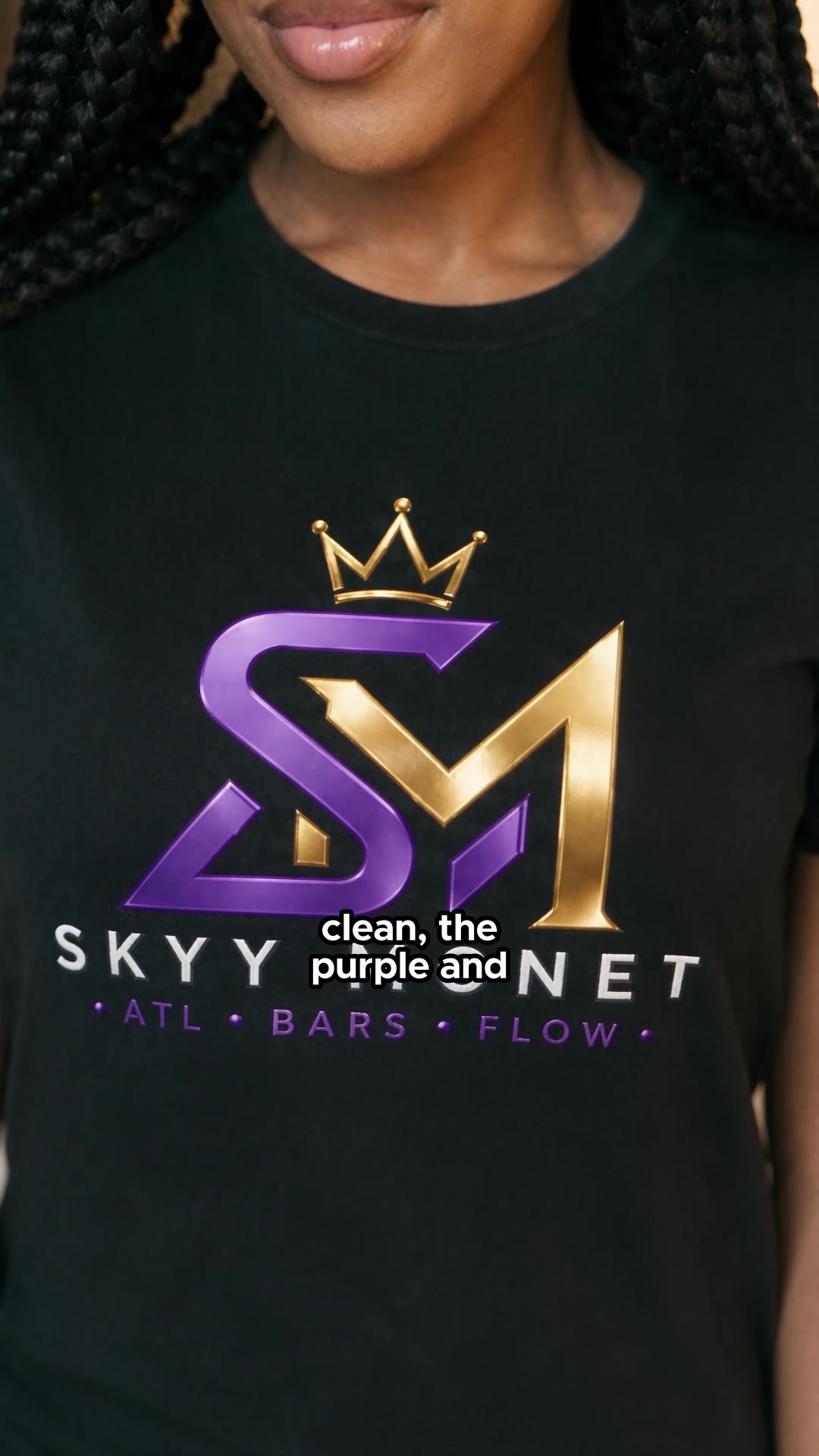 Black tee — purple and gold print